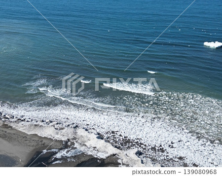 Aerial view of the coastline along the scenic byway with remaining drift ice. Aerial view of the coastline along the scenic byway with remaining drift ice. 139080968