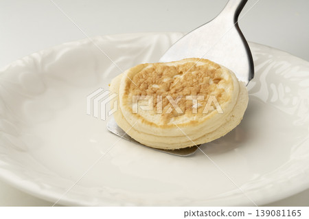 Place the cooked ricotta cheese pancakes on a plate. Place the cooked ricotta cheese pancakes on a plate. 139081165