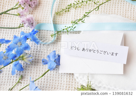 Thank you very much. Here's a thank-you card and some blue flowers, including delphiniums. Thank you very much. Here's a thank-you card and some blue flowers, including delphiniums. 139081632