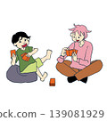 Two brothers, one elementary school student and the other middle school student, with smiles on their faces as they enjoy a card game. 139081929