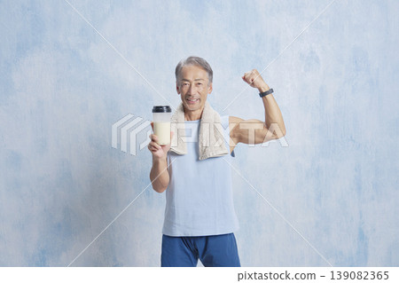 Senior man training with a protein bottle, fist pump Senior man training with a protein bottle, fist pump 139082365