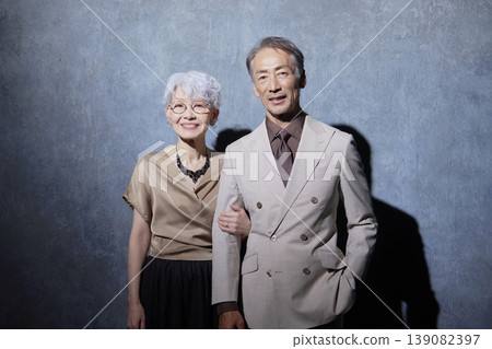 Portrait of a friendly senior couple on a black background Portrait of a friendly senior couple on a black background 139082397