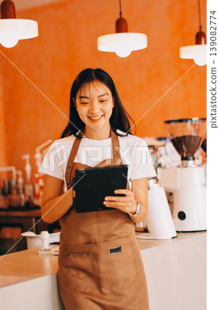 Young woman at barista school learning how to make espresso coffee. 139082774