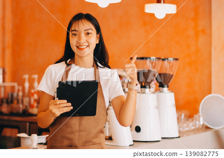 Young woman at barista school learning how to make espresso coffee. 139082775
