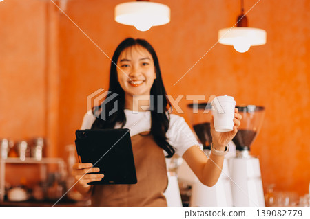 Young woman at barista school learning how to make espresso coffee. 139082779