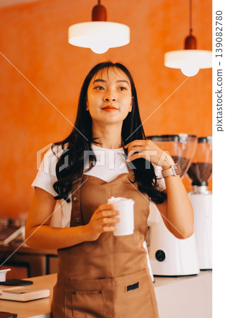Young woman at barista school learning how to make espresso coffee. 139082780