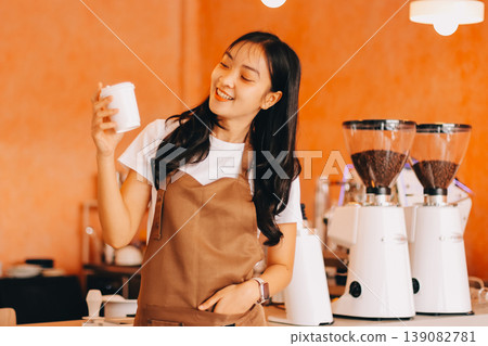 Young woman at barista school learning how to make espresso coffee. 139082781