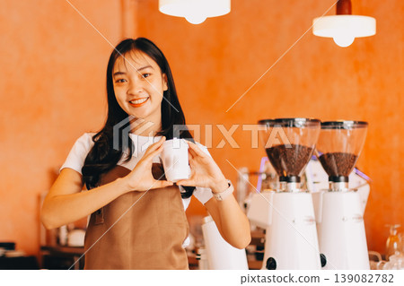 Young woman at barista school learning how to make espresso coffee. 139082782