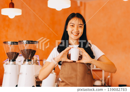 Young woman at barista school learning how to make espresso coffee. 139082783
