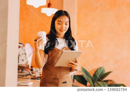 Young woman at barista school learning how to make espresso coffee. 139082784