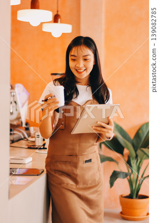 Young woman at barista school learning how to make espresso coffee. 139082785