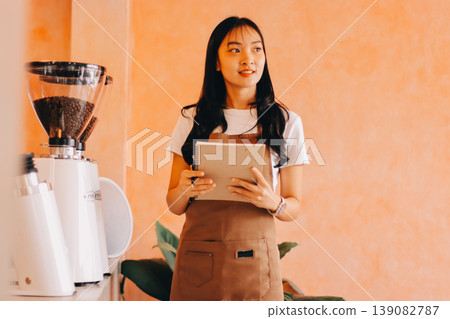 Young woman at barista school learning how to make espresso coffee. 139082787