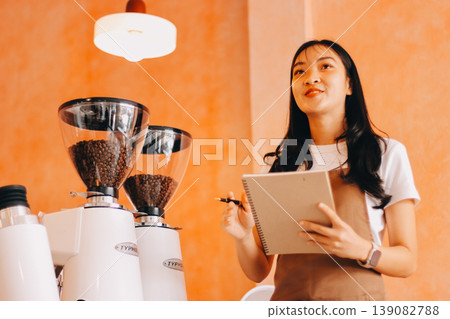Young woman at barista school learning how to make espresso coffee. 139082788