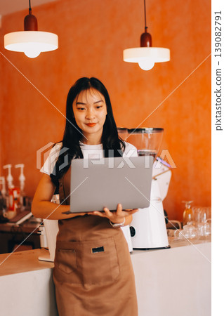 Young woman at barista school learning how to make espresso coffee. 139082791