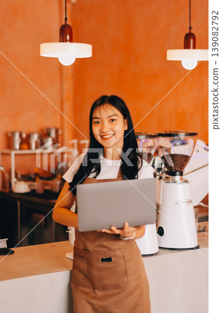 Young woman at barista school learning how to make espresso coffee. 139082792