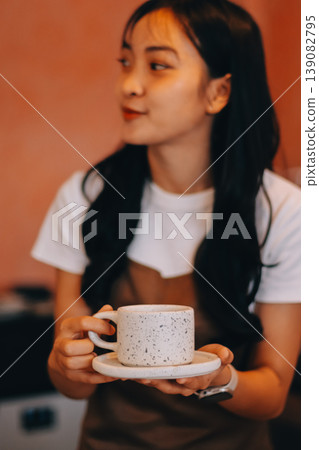 Young woman at barista school learning how to make espresso coffee. 139082795