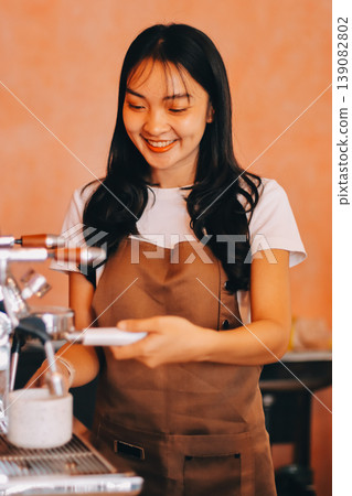 Young woman at barista school learning how to make espresso coffee. 139082802