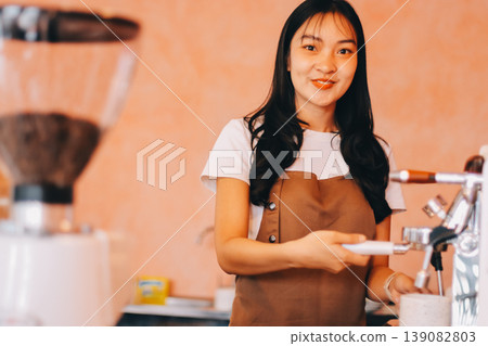 Young woman at barista school learning how to make espresso coffee. 139082803