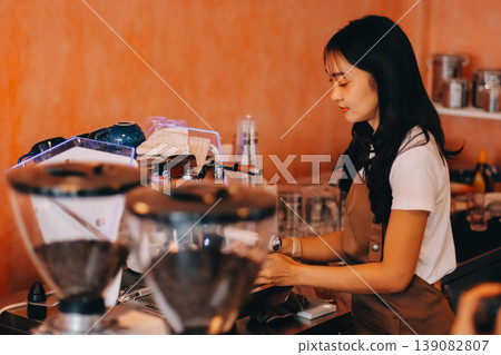Young woman at barista school learning how to make espresso coffee. 139082807
