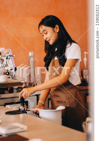 Young woman at barista school learning how to make espresso coffee. 139082813