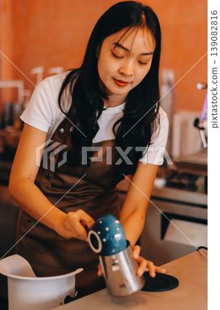 Young woman at barista school learning how to make espresso coffee. 139082816
