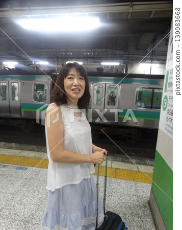 A woman waiting for a train 139083668