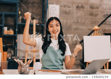 Female artist wears black hat posing near picture indoor the studio Female artist wears black hat posing near picture indoor the studio 139084234