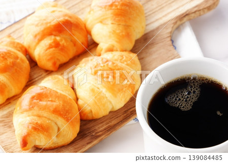 Croissants and coffee - A breakfast scene featuring freshly baked, crispy croissants and freshly brewed coffee. Croissants and coffee - A breakfast scene featuring freshly baked, crispy croissants and freshly brewed coffee. 139084485