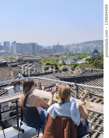 A couple looking out at the city from their balcony. A couple looking out at the city from their balcony. 139084489