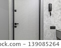 Modern Apartment Security Door with Intercom and Textured Wall 139085264