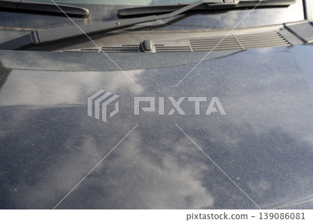 Car hood stained with yellow dust Car hood stained with yellow dust 139086081