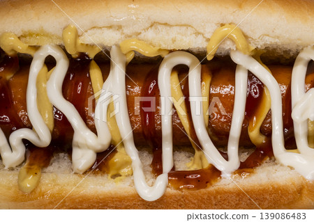 Tasty hot dog with ketchup mayonnaise and mustard Tasty hot dog with ketchup mayonnaise and mustard 139086483