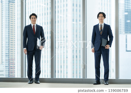 Businessmen holding a meeting in an office. Filming assistance provided by: Denpa Gakuen Educational Foundation, Tokyo Electronics College. Businessmen holding a meeting in an office. Filming assistance provided by: Denpa Gakuen Educational Foundation, Tokyo Electronics College. 139086789
