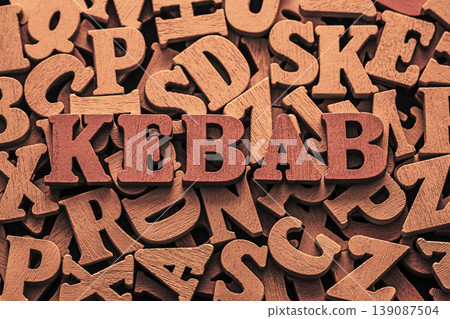 Word kebab on pile of old vintage wooden letters. Word kebab on pile of old vintage wooden letters. 139087504