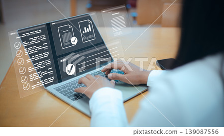 Digital document management system on laptop,Paperless office technology for business efficiency,Data analysis report with virtual interface,Automated business process and information storage. Digital document management system on laptop,Paperless office technology for business efficiency,Data analysis report with virtual interface,Automated business process and information storage. 139087556