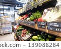 Grocery store produce section with fresh vegetables arranged on shelves in modern supermarket interior 139088284
