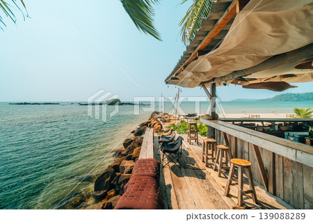 Tropical beach bar terrace with wooden furniture and sea view. 139088289
