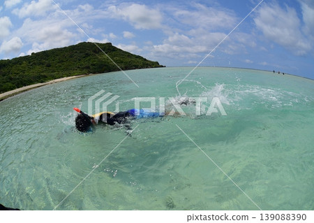 A boy snorkeling in the sea off Miyako Island. A boy snorkeling in the sea off Miyako Island. 139088390