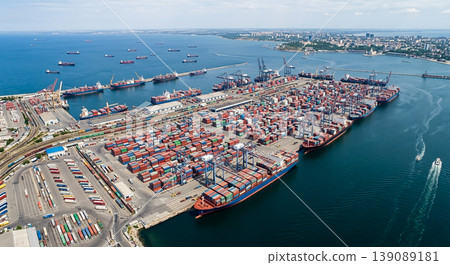 Busy port with cargo ships and containers in the harbor during daytime in an urban area 139089181