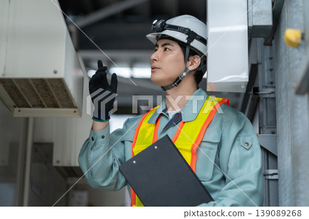 A male engineer performing building maintenance. Photo courtesy of Denpa Gakuen Tokyo Electronics College. A male engineer performing building maintenance. Photo courtesy of Denpa Gakuen Tokyo Electronics College. 139089268