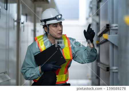 A male engineer performing building maintenance. Photo courtesy of Denpa Gakuen Tokyo Electronics College. 139089276