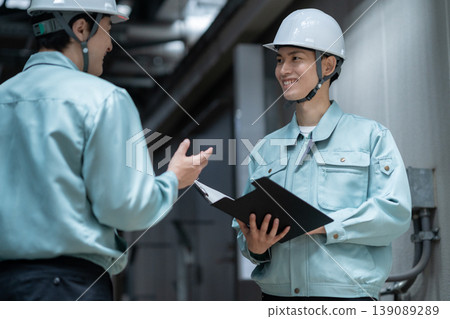 A male engineer performing building maintenance. Photo courtesy of Denpa Gakuen Tokyo Electronics College. 139089289