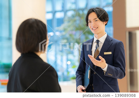 A male concierge working at a hotel. Filming assistance provided by: Denpa Gakuen Educational Foundation, Tokyo Electronics College. A male concierge working at a hotel. Filming assistance provided by: Denpa Gakuen Educational Foundation, Tokyo Electronics College. 139089308