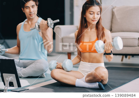 Support, teamwork and fitness couple doing workout training, challenging exercise for endurance, strength and stamina in a gym. Active, fit man and woman giving support and motivation during pushup 139089484