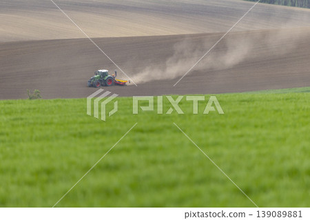 Tractor sowing seeds in a plowed Svatoborice Mistrin field Tractor sowing seeds in a plowed Svatoborice Mistrin field 139089881