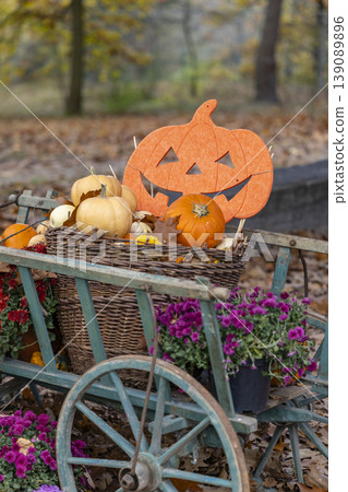 Autumn harvest pumpkins and jack o' lantern on wooden cart Autumn harvest pumpkins and jack o' lantern on wooden cart 139089896