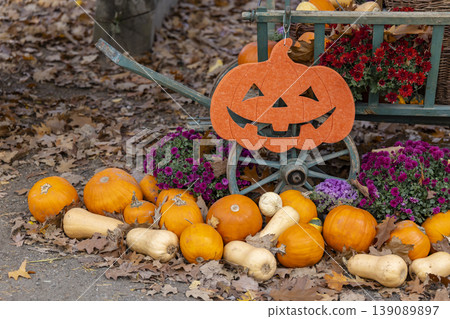 Halloween jack o' lantern decoration with pumpkins and autumn flowers 139089897
