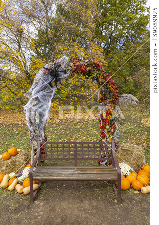 Park bench decorating with autumn pumpkins and Halloween spiderweb arch in Prague Park bench decorating with autumn pumpkins and Halloween spiderweb arch in Prague 139089925