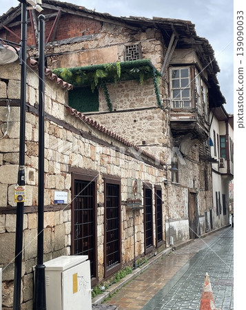 Old stone building on narrow cobblestone street reflecting historical architecture Old stone building on narrow cobblestone street reflecting historical architecture 139090033