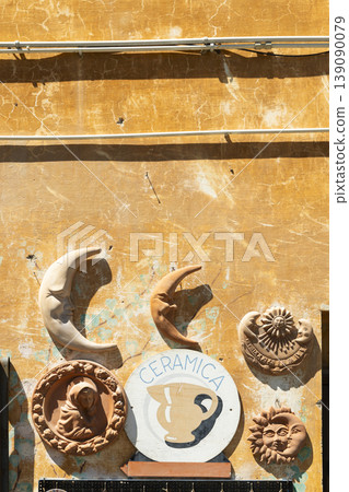 Artisan ceramics hanging on an old wall in Italy 139090079